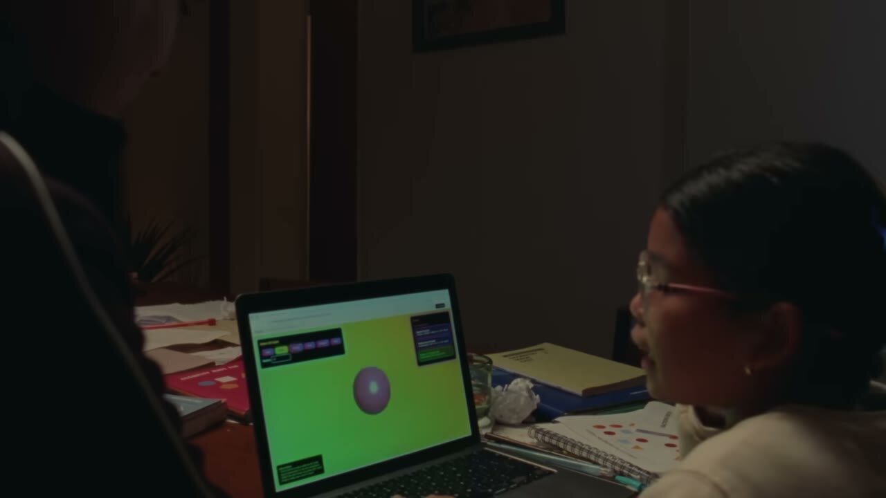 A young person working at a laptop