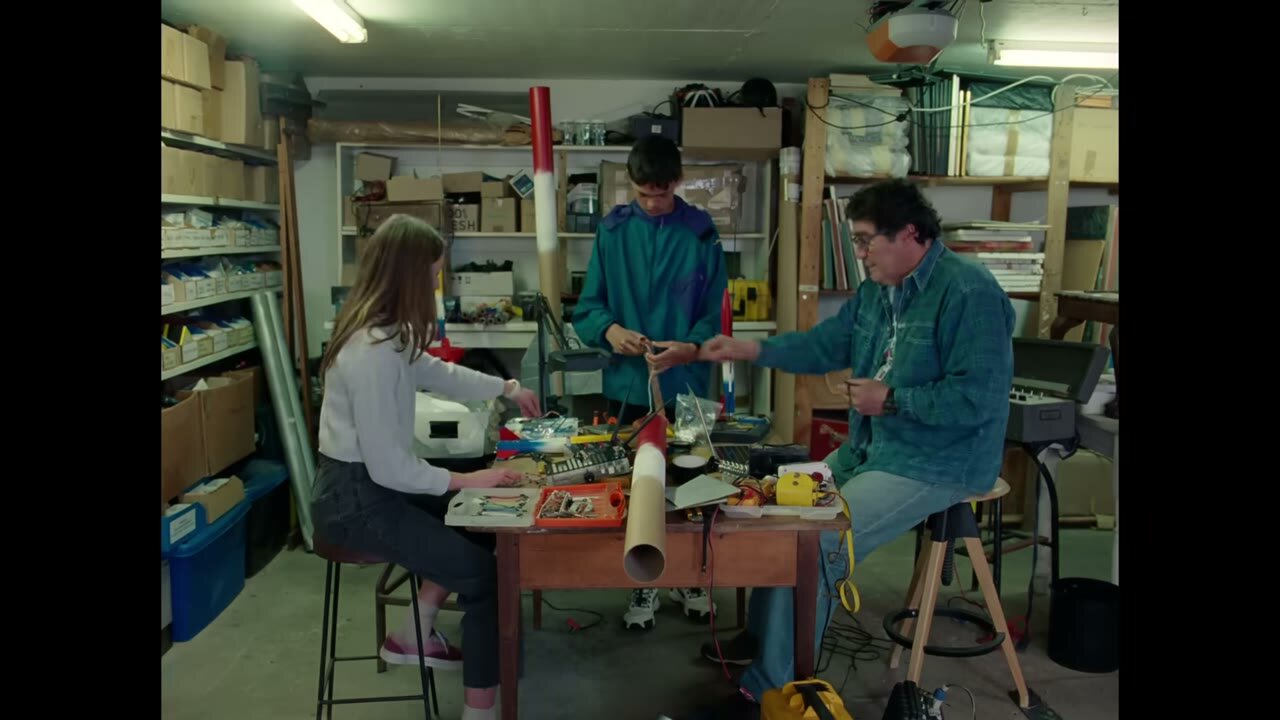 People building in a cluttered workshop