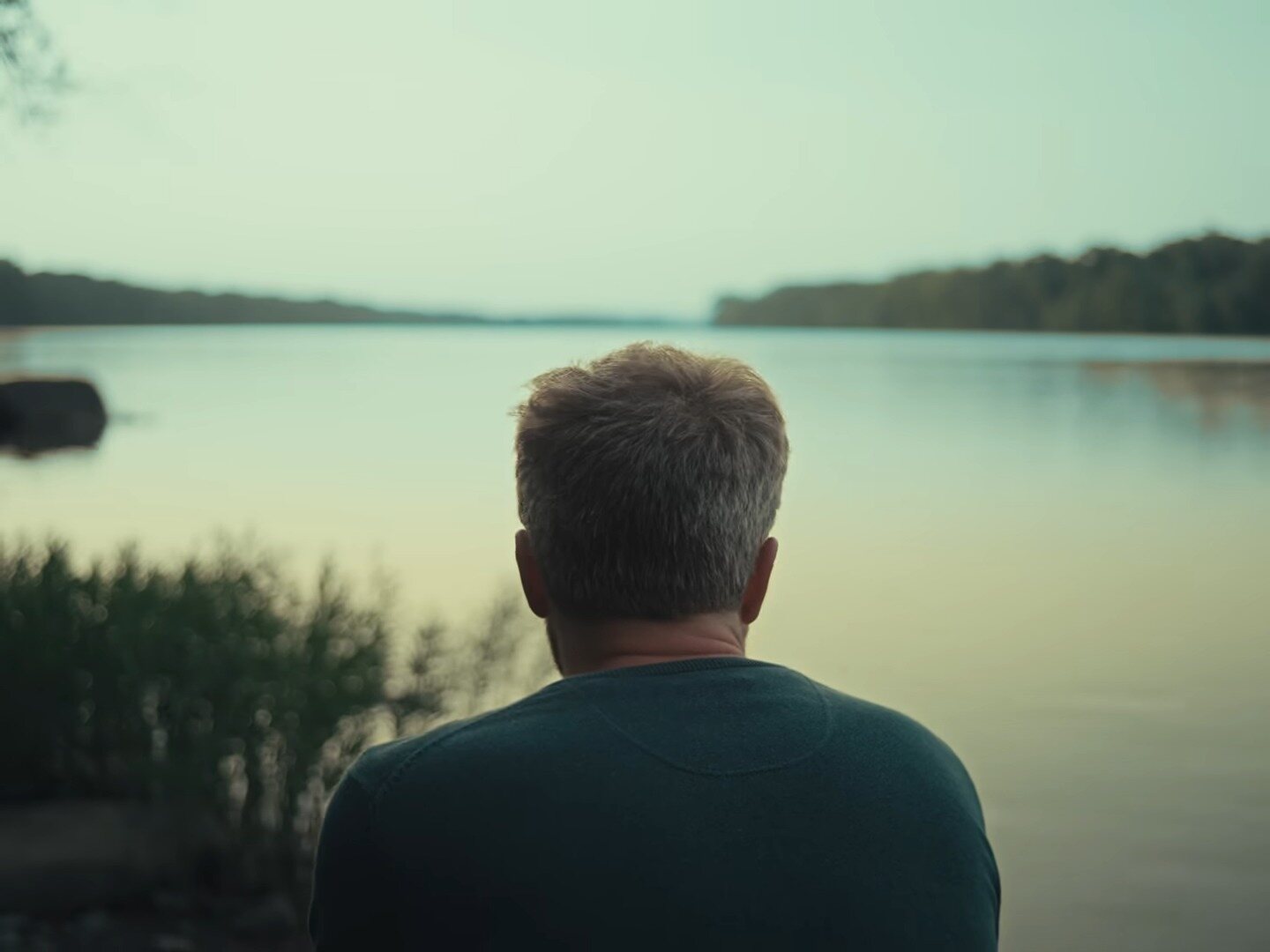 A scientist looking out over a lake