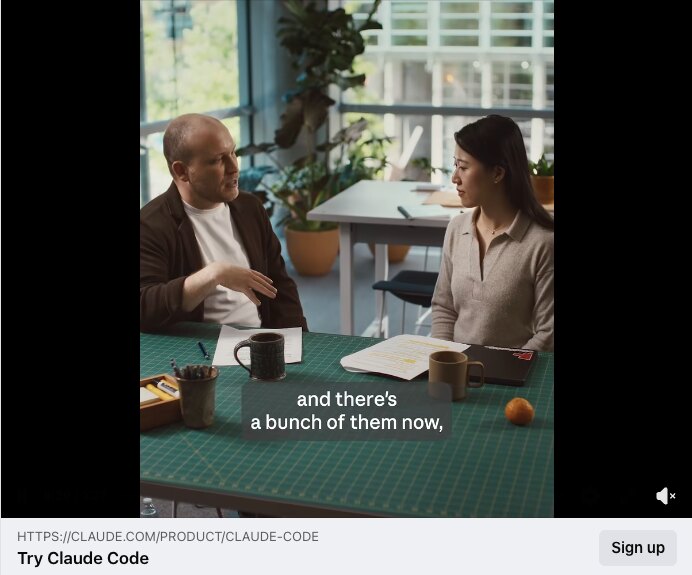 Two people talking across a desk