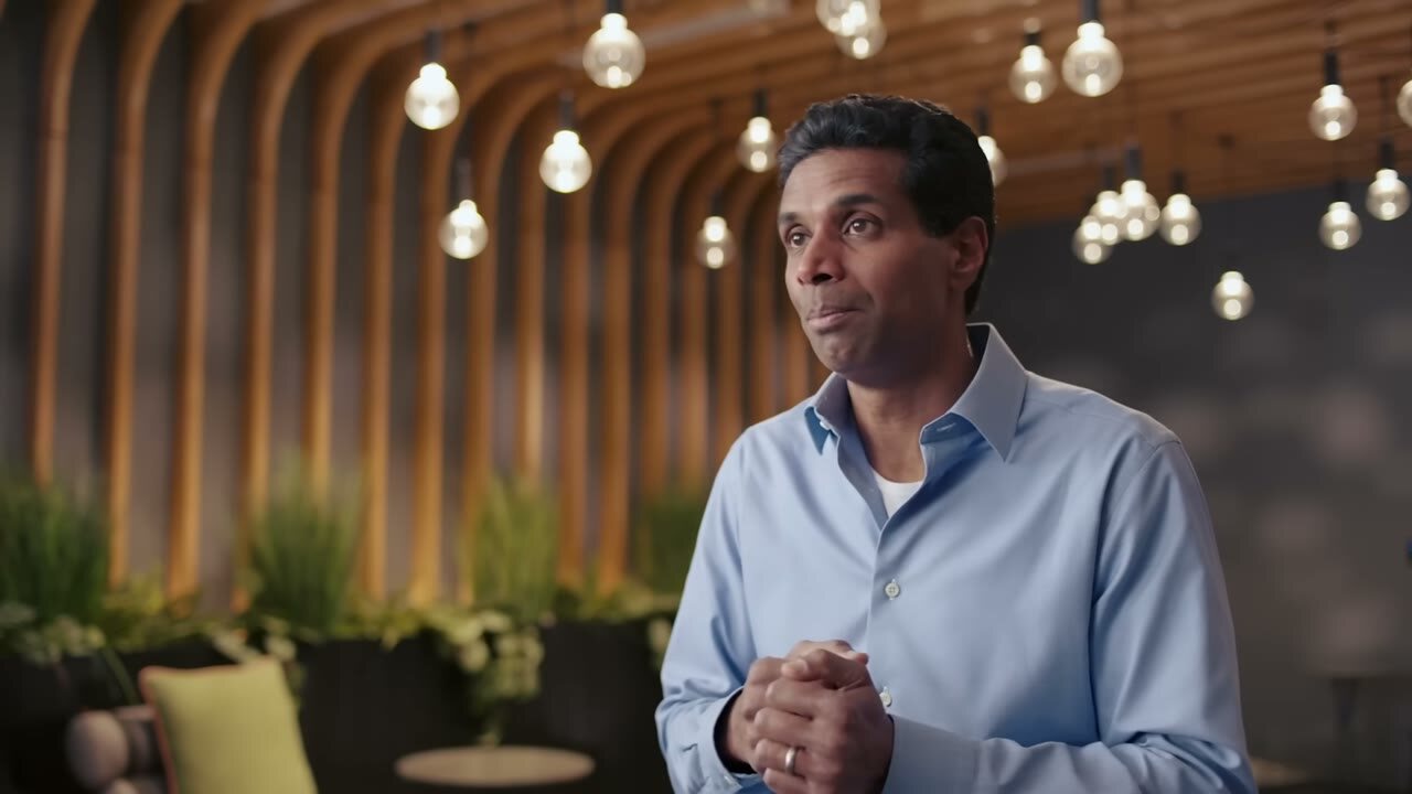 A researcher speaking in a warm, planted interior
